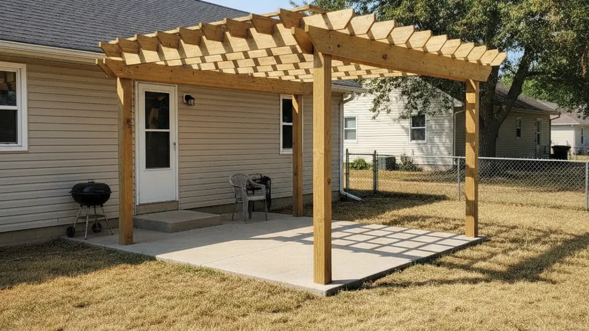 Finished simple pergola over Wamego Kansas backyard patio with dry Flint Hills summer grass